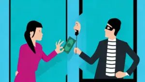 Una persona consegna denaro a un truffatore mascherato attraverso uno schermo