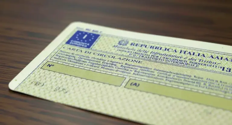 Carta di circolazione italiana appoggiata su una superficie in legno