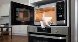 Forno a microonde acceso con una ciotola bianca all'interno in una cucina moderna