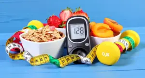 Misuratore di glicemia accanto a ciotole con cereali, frutta fresca, pesi e metro da sarta
